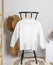 Long sleeve shirt hanged on to a chair with minimalist decorations