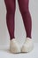 Long slender legs close-up. Thick-soled sneakers. Red stockings or tights. Trend, fashion, trend