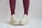 Long slender legs close-up. Thick-soled sneakers. Red stockings or tights. Trend, fashion, trend