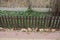 Long small decorative fence made of brown wooden boards