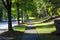 A long smooth sidewalk surrounded by lush green grass and lush green trees on a residential street in South Fulton