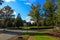 A long smooth sidewalk surrounded by lush green grass and lush green trees on a residential street in South Fulton