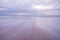 Long speed shutter of tropical sandy beach with sky and clouds over sea