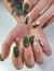 Long square nails with swamp-green gel polish. Green manicure with geometric design of black stripes