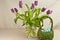 Long stemmed, purple, long stemmed tulips and  artisan, grass, easter basket, filler with colorful, easter eggs