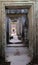 A long stone corridor in an old dilapidated building. Empty doorway