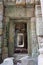 A long stone corridor in an old dilapidated building. Empty doorway