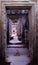 A long stone corridor in an old dilapidated building. Empty doorway