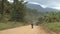 Long straight dirt road in open African landscape