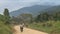 Long straight dirt road in open African landscape