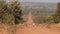 Long straight dirt road in open African landscape