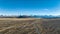 Long straight highway through farmland on the way to Lake Tekapo