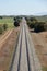 Long straight train tracks in an Andalusian agricultural landscape