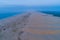 Long strech of sand dunes near the ocean at dawn.