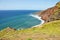 Long stretch of beach under an eroding cliff