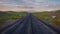Long stretch of empty road through desert leading to distant mountains. 3D rendering