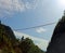 Long suspension bridge between two mountains with many intrepid