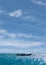 Long tail boat silhouette on the high sea against blue sky background, the Andaman Sea, Krabi, Thailand