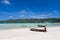 Long tail boat Sits on the beach with mountain background