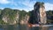 Long Tailed Boat with amazing cliff in the background, Krabi, Thailand