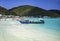 Long-tailed flat-bottomed boats and speed boats moored to pick up tourists in front of Ta Waen Beach, Koh Larn, Pattaya