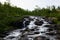 Long-term photos of a river through stones and  the green nature in norway