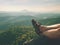 Long tired naked legs in hiking sandals on peak. Hiking in sandstone rocks, hilly landscape