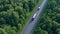 A long truck and a semi-truck follow each other to their destination. Cargo. The highway is laid through the picturesque