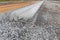 Long view down freshly extruded street curb, concrete extrusion road construction