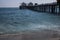 Long view of Malibu pier in California with two cafe buildings