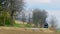 Long View of a Restored Antique Steam Locomotive Approaching Up a Grade, Blowing Smoke