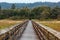 long walking boardwalk leading over wetlands to forest