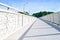 Long walking path in a modern white metal bridge