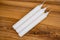 Long wax candles. Three white wax candles on a wooden background. Set of traditional candles