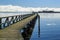 Long, weathered wooden wharf on lake