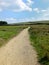 A long winding footpath running into the distance in stoodley moor in yorkshire with fields and farms in the distance