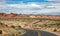 Long winding highway with ups and downs, cloudy blue sky. Valley of Fire Nevada, USA