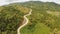 A long and winding road passing through green hills. Busuanga island. Coron. Aerial view. Philippines.