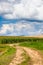 Long and winding rural road crosses the hills and fields