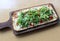 Long wood plank with flavorful flatbread as appetizer at restaurant