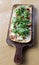 Long wood plank with flavorful flatbread as appetizer at restaurant