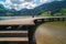 Long wooden boardwalk on a calm and placid mountain lake with a great view