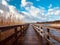 Long wooden jetty at waterside - straight wood pier walkway