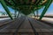 Long wooden and metal Gdanski bridge with tram rails and green roof