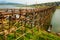 Long wooden Mon bridge damaged by stream of srtong flood