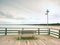 Long wooden pier on Baltic coast during morning calm. Cold weather, silent day