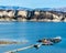 Long wooden pier and boats at California`s Lake Cachuma with San Rafael Mountains