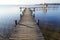 a long wooden pier in Herrsching on Lake Ammersee in Bavaria on a clear December day (Germany)