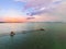 Long wooden pier on the sea during sunset