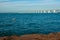 Long Zeeland Bridge, deep blue water with buoy, some wind turbines in the background